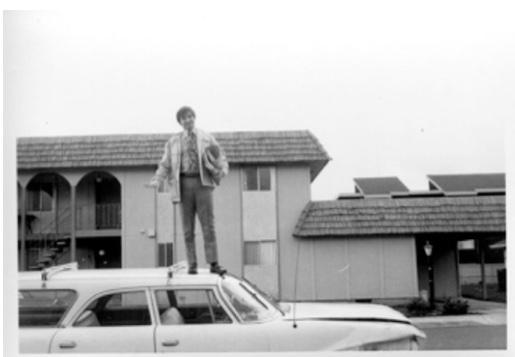 Joseph Najdek standing on a car